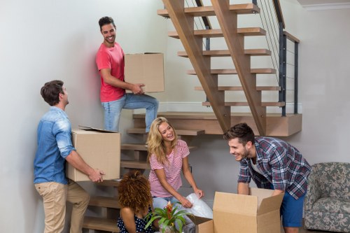 Moving team handling belongings safely with insurance and protective equipment