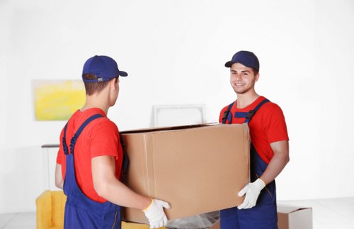 Removal team loading boxes in a West Hampstead residential street