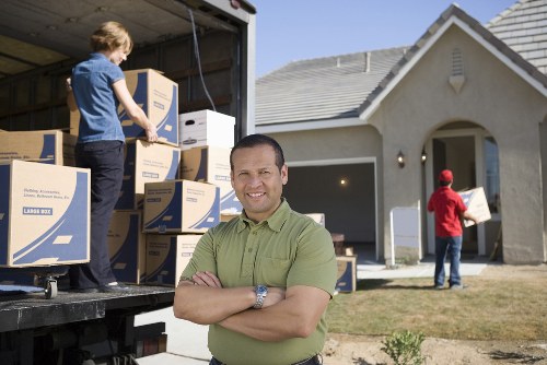 Moving crew wearing protective gear while loading items for transport