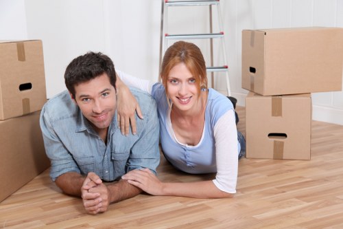 Removal team managing furniture in a Westhampstead flat move